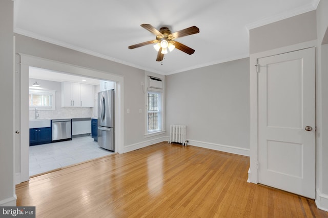 4441 Sherwood Rd, Philadelphia, PA 19131 - unfurnished living room featuring radiator heating unit, ceiling fan, light wood finished floors, and ornamental molding