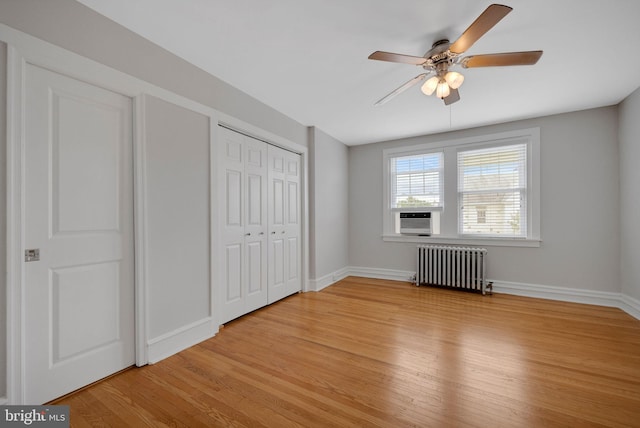 4441 Sherwood Rd, Philadelphia, PA 19131 - unfurnished bedroom with radiator heating unit, light wood-style floors, baseboards, a closet, and cooling unit