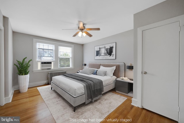 4441 Sherwood Rd, Philadelphia, PA 19131 - bedroom with radiator heating unit, wood finished floors, cooling unit, baseboards, and ceiling fan