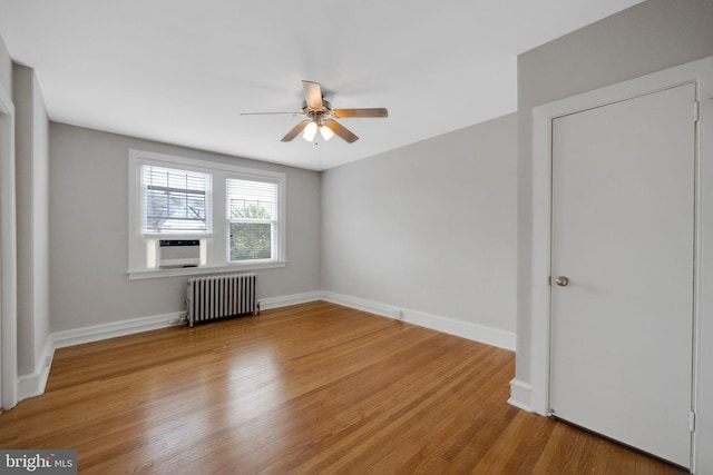 4441 Sherwood Rd, Philadelphia, PA 19131 - unfurnished bedroom featuring radiator heating unit, wood finished floors, baseboards, cooling unit, and a ceiling fan