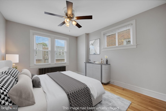 4441 Sherwood Rd, Philadelphia, PA 19131 - bedroom with radiator heating unit, light wood finished floors, baseboards, and a ceiling fan