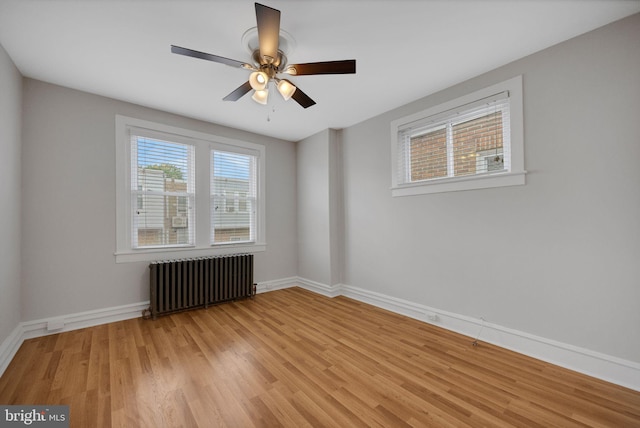 4441 Sherwood Rd, Philadelphia, PA 19131 - unfurnished room featuring radiator, light wood-style floors, a ceiling fan, and baseboards