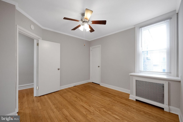 4441 Sherwood Rd, Philadelphia, PA 19131 - unfurnished bedroom with radiator heating unit, light wood finished floors, multiple windows, and crown molding