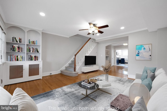 4441 Sherwood Rd, Philadelphia, PA 19131 - living area featuring wood finished floors, arched walkways, a ceiling fan, stairway, and baseboards