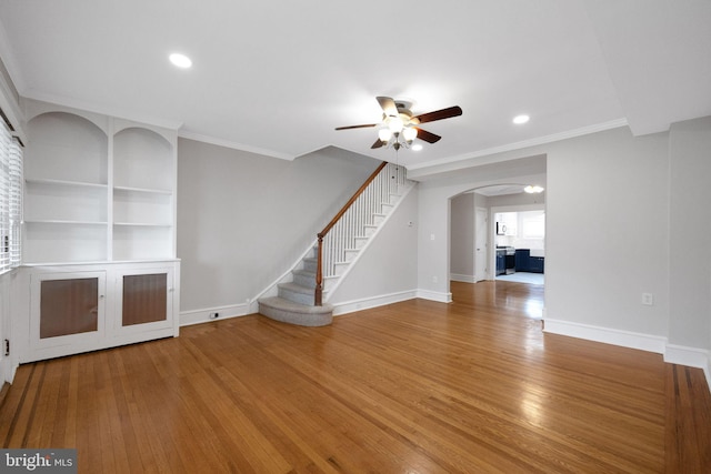 4441 Sherwood Rd, Philadelphia, PA 19131 - unfurnished living room featuring ceiling fan, arched walkways, wood finished floors, baseboards, and ornamental molding