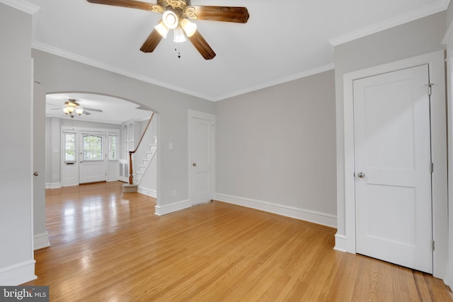 4441 Sherwood Rd, Philadelphia, PA 19131 - unfurnished room featuring a ceiling fan, arched walkways, light wood-style floors, stairway, and crown molding