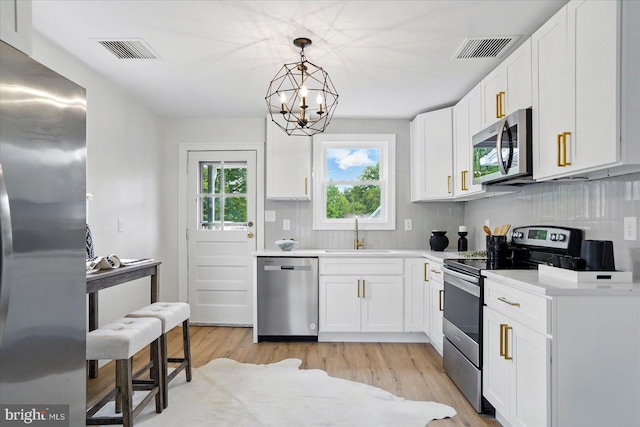 12 N Hawthorne Rd N, Middle River, MD 21220 - kitchen featuring appliances with stainless steel finishes, a sink, tasteful backsplash, and white cabinets