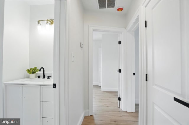12 N Hawthorne Rd N, Middle River, MD 21220 - hall featuring a sink, light wood finished floors, and baseboards