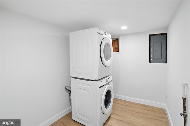 12 N Hawthorne Rd N, Middle River, MD 21220 - washroom with electric panel, stacked washer / dryer, baseboards, light wood-style flooring, and recessed lighting