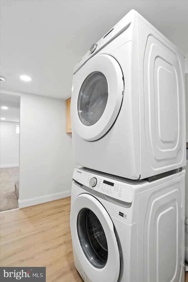 12 N Hawthorne Rd N, Middle River, MD 21220 - washroom with stacked washing machine and dryer, baseboards, light wood-type flooring, and recessed lighting
