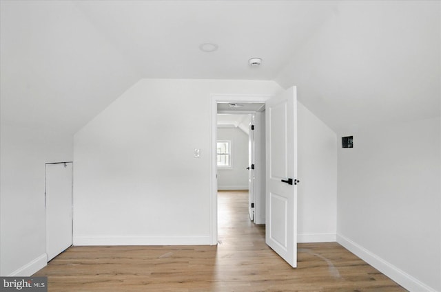 12 N Hawthorne Rd N, Middle River, MD 21220 - additional living space with vaulted ceiling, light wood-type flooring, and baseboards