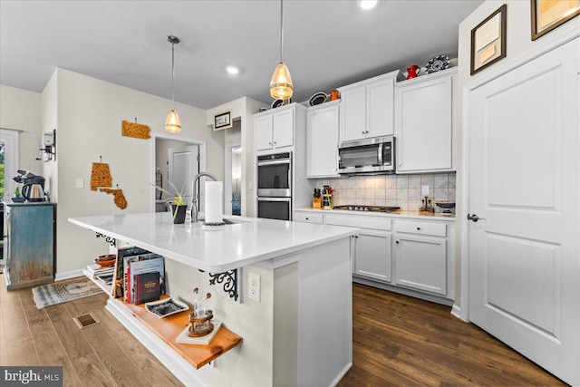 8051 Keystone Dr, Breinigsville, PA 18031 - kitchen featuring stainless steel appliances, recessed lighting, dark wood-style flooring, backsplash, and a kitchen island with sink
