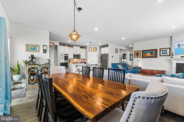 8051 Keystone Dr, Breinigsville, PA 18031 - dining room featuring dark wood-style floors, recessed lighting, and a fireplace