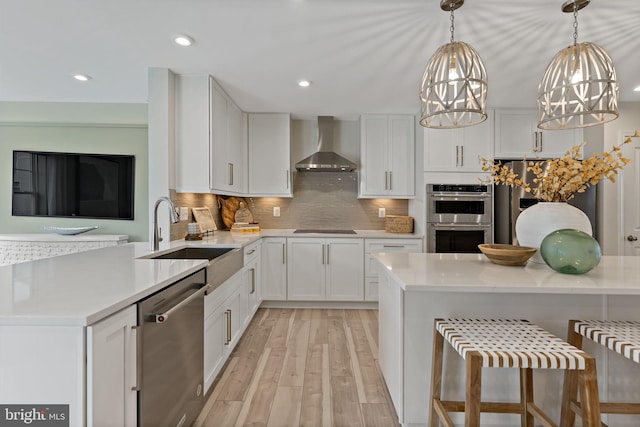 TBB Fontana Circle Whitehall Ii, Martinsburg, WV 25403 - kitchen featuring wall chimney range hood, stainless steel appliances, a sink, light countertops, and recessed lighting