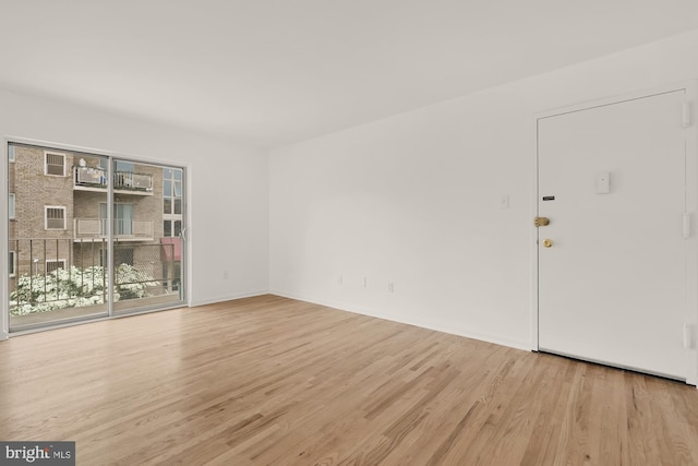 7056 Eastern NW Unit 308, Washington, DC 20012 - unfurnished room with light wood finished floors and baseboards