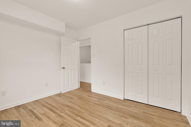7056 Eastern NW Unit 308, Washington, DC 20012 - unfurnished bedroom featuring light wood-style flooring, baseboards, and a closet
