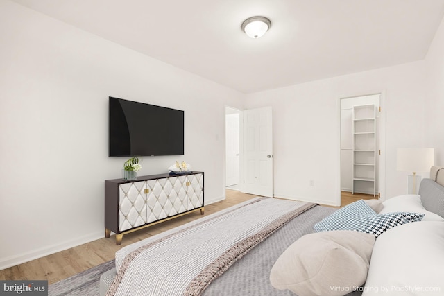 7056 Eastern NW Unit 308, Washington, DC 20012 - bedroom with wood finished floors, baseboards, and a spacious closet