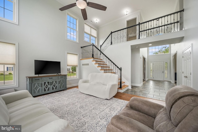 20 Doe Hill Ct, Camden Wyoming, DE 19934 - living room featuring a high ceiling, plenty of natural light, stairway, baseboards, and a ceiling fan
