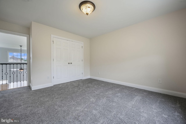 20 Doe Hill Ct, Camden Wyoming, DE 19934 - unfurnished bedroom featuring dark carpet, baseboards, and a closet