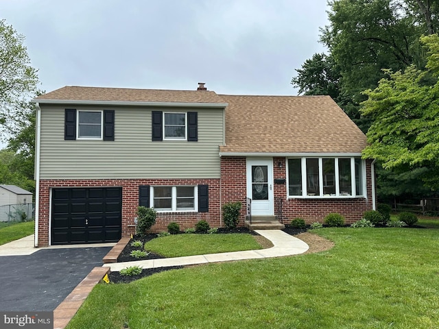 503 Poplar Rd, Flourtown, PA 19031 - tri-level home featuring asphalt driveway, brick siding, and a front yard
