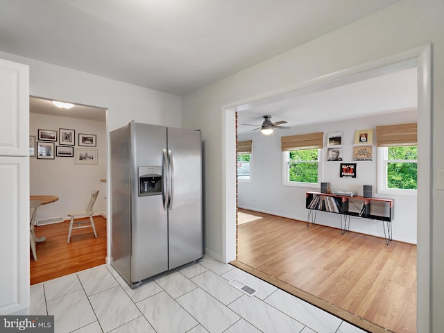 8579 Main Ave, Pasadena, MD 21122 - kitchen featuring stainless steel fridge with ice dispenser, a ceiling fan, baseboards, light wood-style floors, and white cabinetry
