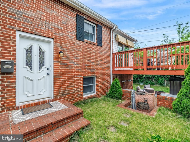 8579 Main Ave, Pasadena, MD 21122 - entrance to property with a wooden deck, a lawn, and brick siding
