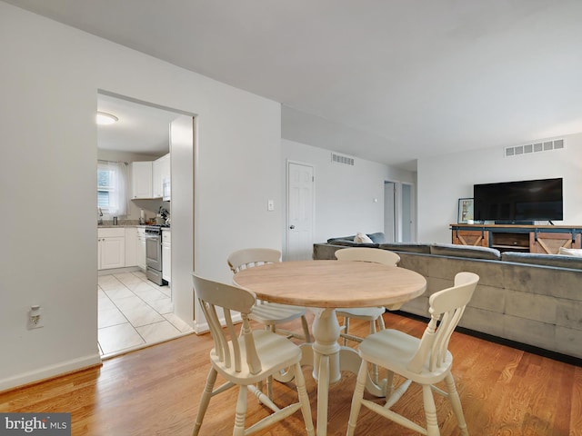 8579 Main Ave, Pasadena, MD 21122 - dining room with light wood-type flooring and baseboards