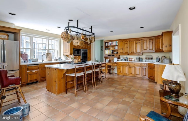 528 E Center Ave, Newtown, PA 18940 - kitchen with freestanding refrigerator, open shelves, black microwave, a kitchen bar, and light countertops