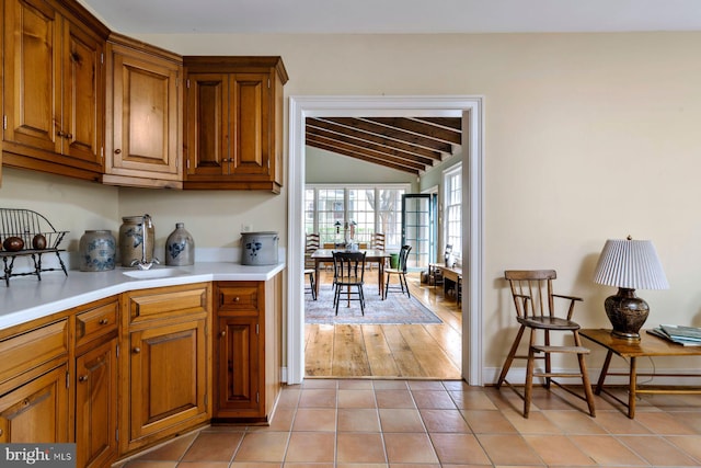 528 E Center Ave, Newtown, PA 18940 - kitchen featuring vaulted ceiling, brown cabinets, light countertops, and light tile patterned floors