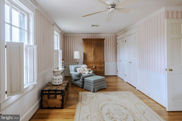 528 E Center Ave, Newtown, PA 18940 - sitting room with wallpapered walls, light wood finished floors, crown molding, a ceiling fan, and baseboards