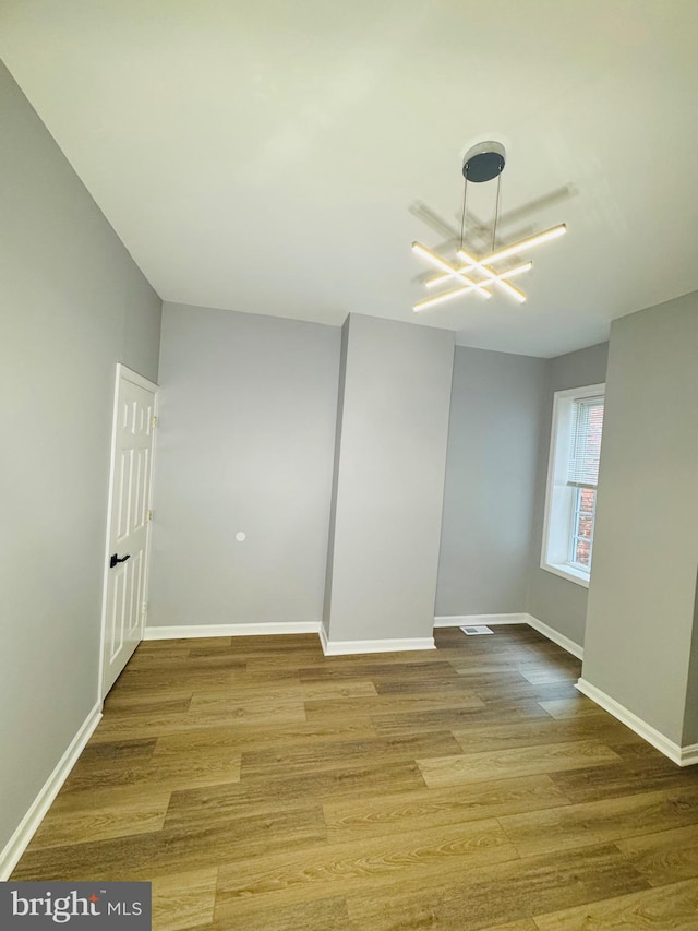 1402 W Saratoga St, Baltimore, MD 21223 - empty room with wood finished floors and baseboards