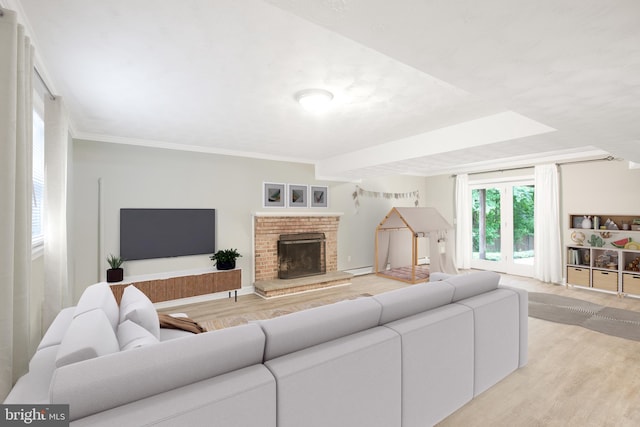 8007 Lewinsville Rd, Mclean, VA 22102 - living room featuring light wood-style floors, a fireplace, and ornamental molding