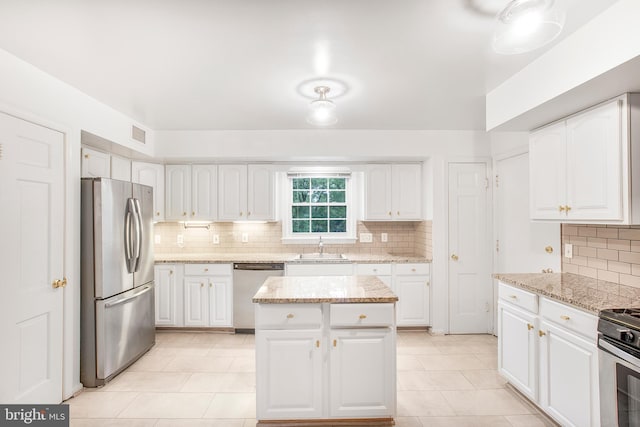 8007 Lewinsville Rd, Mclean, VA 22102 - kitchen featuring appliances with stainless steel finishes, tasteful backsplash, white cabinets, and light tile patterned flooring