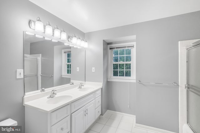 8007 Lewinsville Rd, Mclean, VA 22102 - bathroom featuring a shower with door, double vanity, tile patterned floors, and baseboards