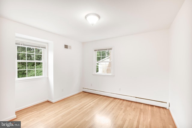 8007 Lewinsville Rd, Mclean, VA 22102 - empty room with a baseboard heating unit, wood finished floors, and baseboards