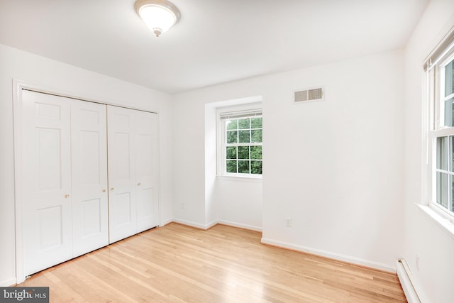 8007 Lewinsville Rd, Mclean, VA 22102 - unfurnished bedroom with baseboard heating, light wood finished floors, baseboards, and a closet