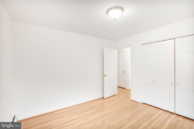 8007 Lewinsville Rd, Mclean, VA 22102 - unfurnished bedroom with light wood-type flooring, a closet, and baseboards