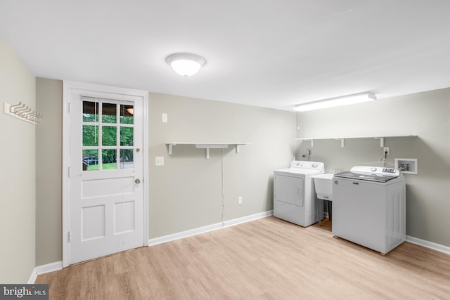 8007 Lewinsville Rd, Mclean, VA 22102 - laundry area with washer and clothes dryer, light wood finished floors, and baseboards