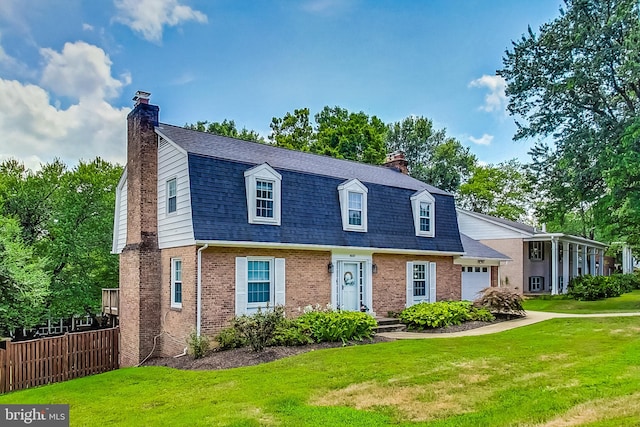 8007 Lewinsville Rd, Mclean, VA 22102 - colonial inspired home with a chimney, brick siding, a garage, a gambrel roof, and roof with shingles