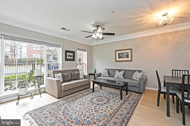 15255 Leicestershire St, Woodbridge, VA 22191 - living room featuring light wood-style flooring, ceiling fan, ornamental molding, a chandelier, and baseboards