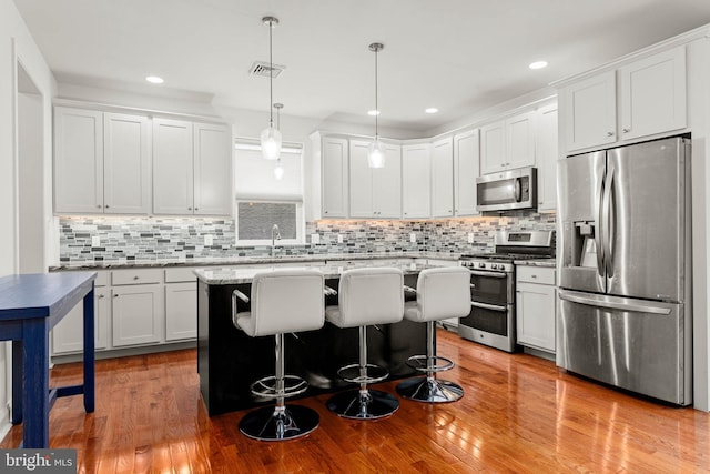 255 Summit Ave, Conshohocken, PA 19428 - kitchen featuring appliances with stainless steel finishes, a sink, decorative backsplash, a kitchen island, and recessed lighting