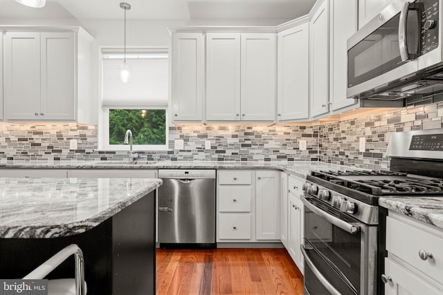 255 Summit Ave, Conshohocken, PA 19428 - kitchen with stainless steel appliances, a sink, white cabinetry, and backsplash