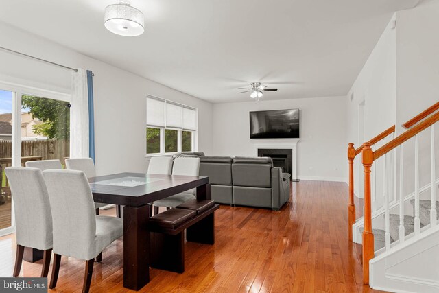 255 Summit Ave, Conshohocken, PA 19428 - dining space featuring stairs, light wood finished floors, ceiling fan, and a fireplace