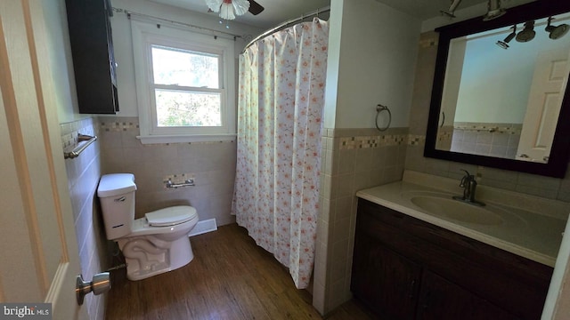 426 Parkwynne Rd, Lancaster, PA 17601 - bathroom featuring tile walls, toilet, wood finished floors, vanity, and a wainscoted wall