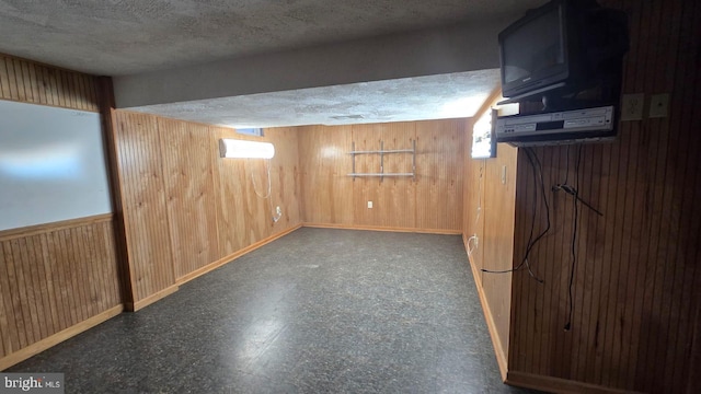 426 Parkwynne Rd, Lancaster, PA 17601 - basement featuring wood walls, a textured ceiling, tile patterned floors, and baseboards