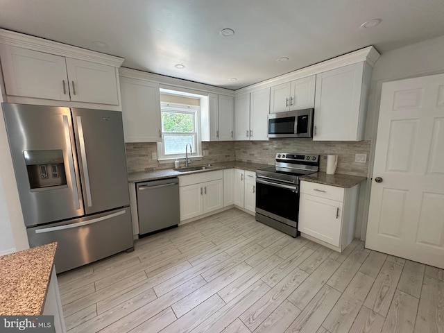 426 Parkwynne Rd, Lancaster, PA 17601 - kitchen with appliances with stainless steel finishes, a sink, white cabinets, light wood-style floors, and recessed lighting