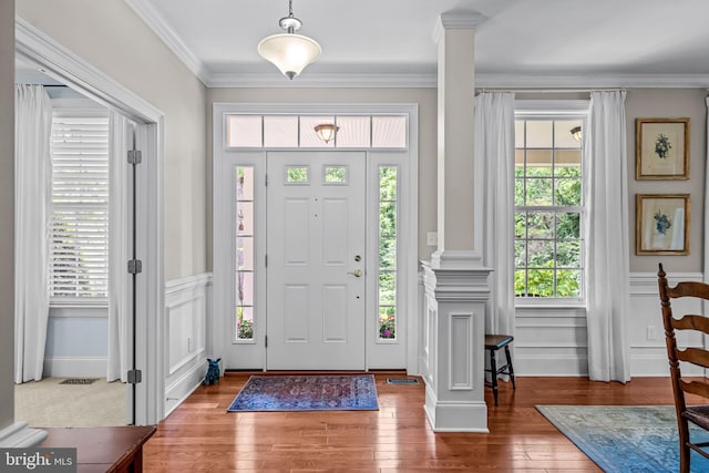 1165 Fulling Mill Ln, Haddon Heights, NJ 08035 - foyer entrance with ornate columns, plenty of natural light, wood finished floors, ornamental molding, and a wainscoted wall