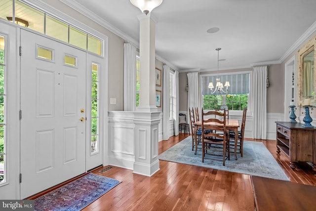 1165 Fulling Mill Ln, Haddon Heights, NJ 08035 - entryway featuring ornate columns, hardwood / wood-style flooring, crown molding, a chandelier, and a wainscoted wall