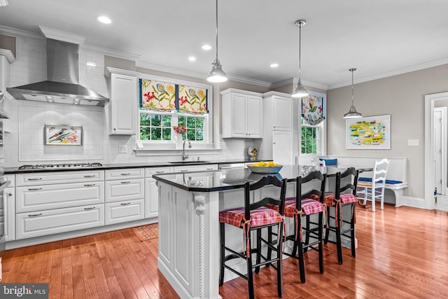 1165 Fulling Mill Ln, Haddon Heights, NJ 08035 - kitchen with wall chimney exhaust hood, dark countertops, light wood-style flooring, gas stovetop, and ornamental molding