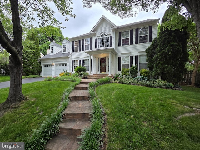 316 Oakcrest Manor Dr NE, Leesburg, VA 20176 - colonial-style house with a front yard, a garage, and asphalt driveway